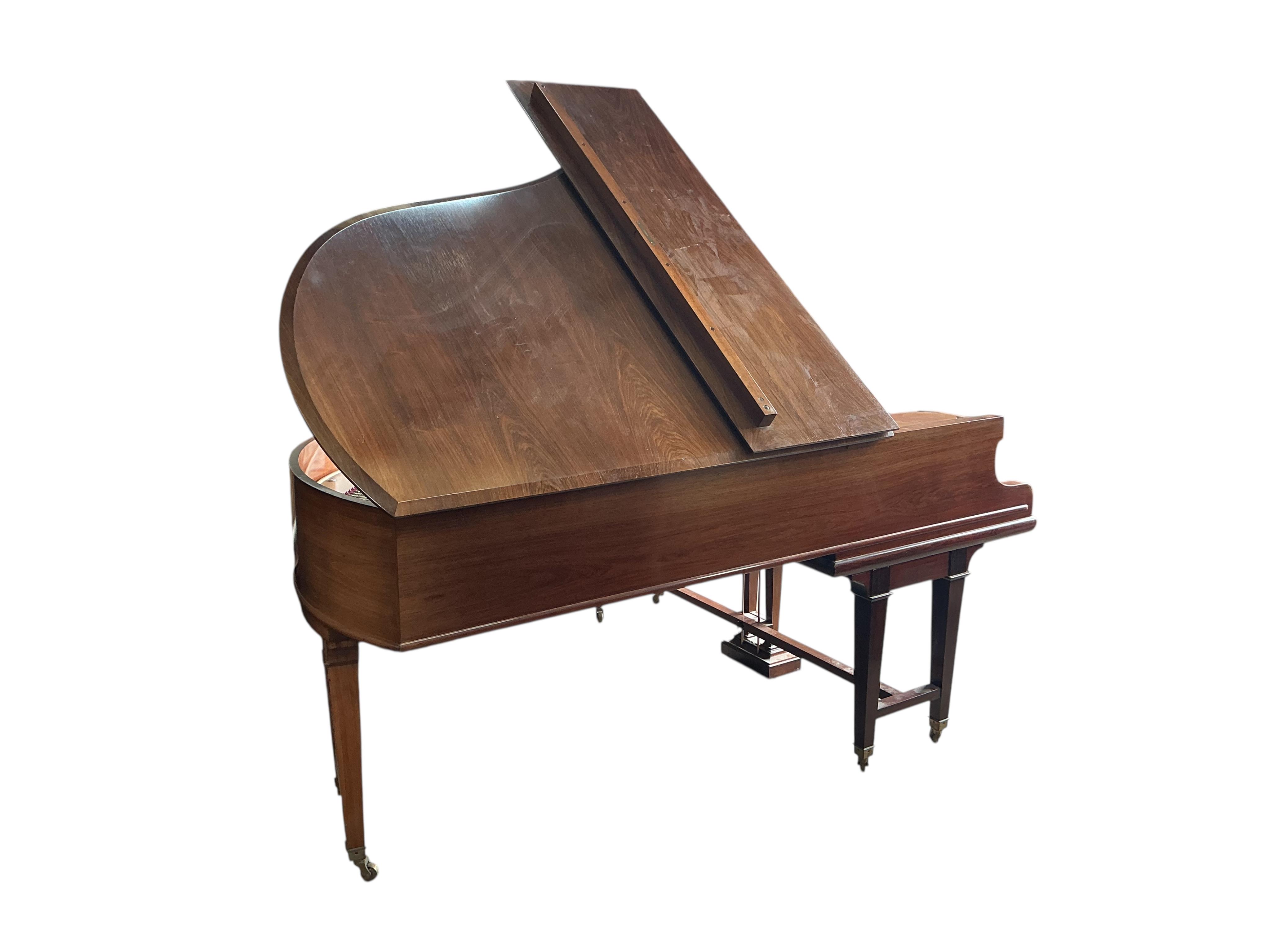 An early 20th century Bechstein 6ft. 8in. rosewood grand piano retailed by Harrods and duet piano stool